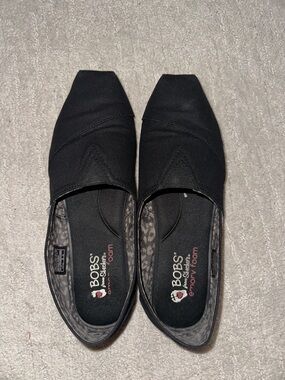 BOBS from Skechers Black Canvas Slip-On Shoes with Pink Logo